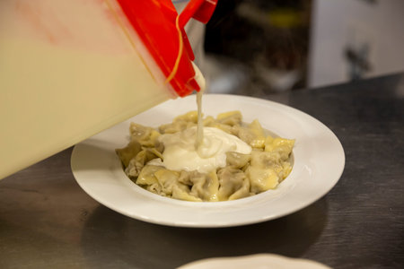 Ravioli - Turkish Manti on plate with red pepper