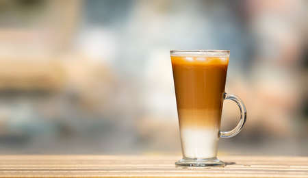 Closeup one glass with ice latte on wooden table. Selective focusの写真素材