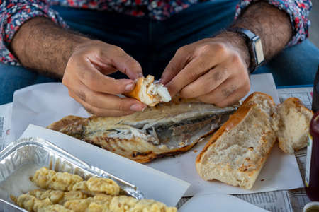 Close up man eating fishの写真素材