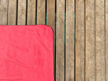Red beach towel on wooden floorの写真素材