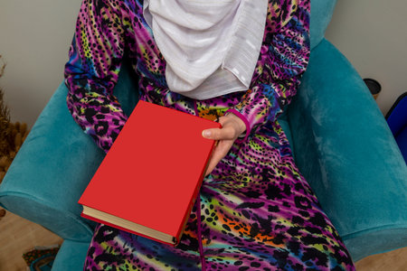 woman hand holding Quran book