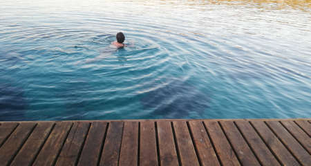 Top view woman with fishes in the seaの写真素材