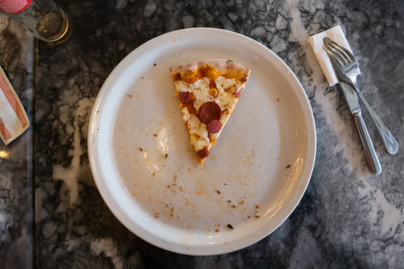 1 slice of pizza in a white plateの写真素材