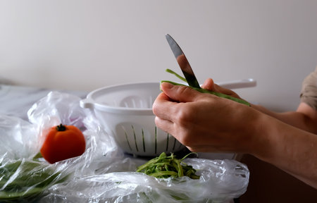 Woman cutting Green beans. close up