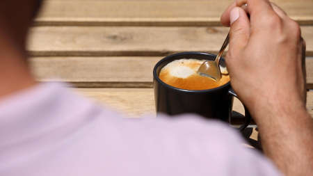 hand stirring Coffee, top viewの写真素材