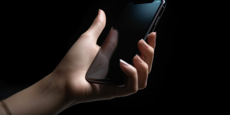 Hand holding smartphone device touching screenの素材