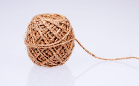 Ball of string on white background