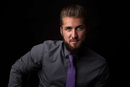 Attractive businessman in front of a black backgroundの写真素材