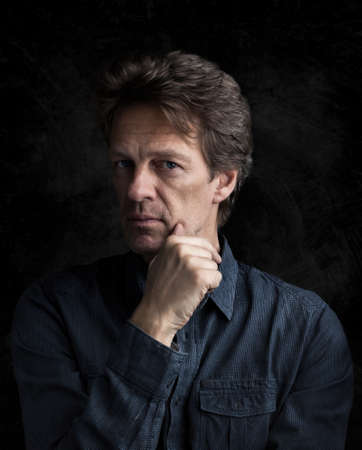 Portrait of an attractive man in front of a black backgroundの写真素材