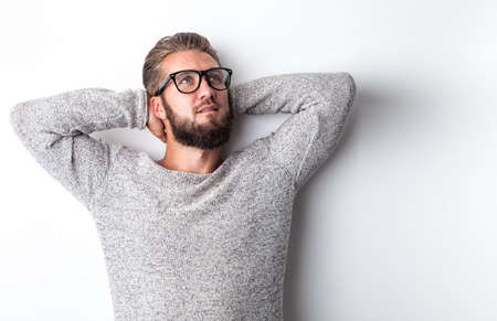Attractive young man with a beard and glasses is relaxingの写真素材