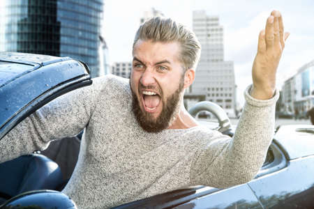 angry man driving a carの写真素材