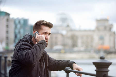 Attractive man in Berlin is talking on the telephoneの写真素材