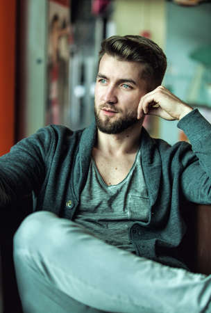 Portrait of a attractive man with a beard in a restaurantの写真素材