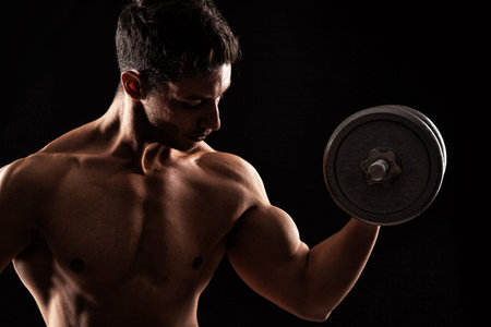Powerful muscular man lifting weights