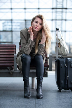 Young beautiful woman is waiting for the trainの写真素材