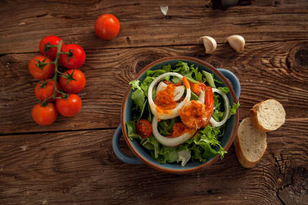 Healthy salad plate on a dark wooden tableの写真素材