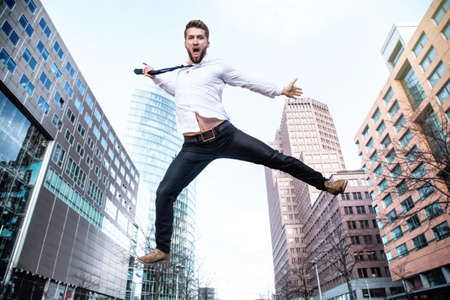 Attractive business man is jumping in the airの写真素材