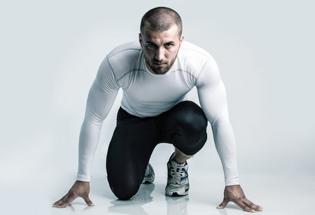 Attractive athlete in starting position
