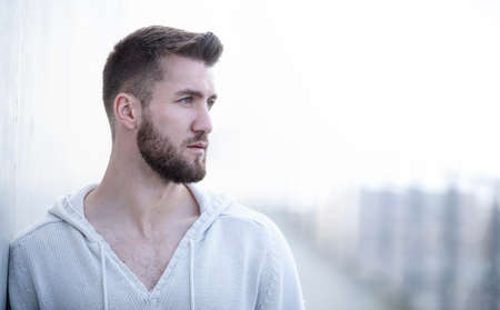 Portrait of an attractive man with a white sweaterの写真素材