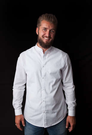 Portrait of a happy young businessman on a black backgroundの写真素材