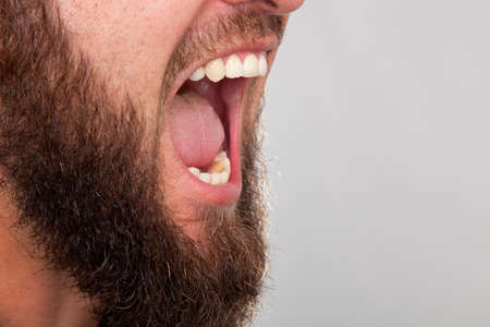 Close up of a man shouting at an angry manの写真素材