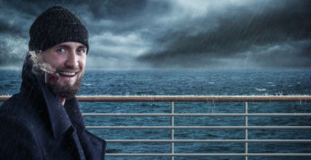 Attractive seafarer on his ship in bad weatherの写真素材