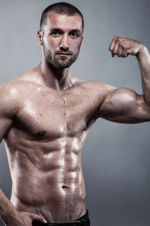 Attractive athlete with strong biceps and perfect absの写真素材