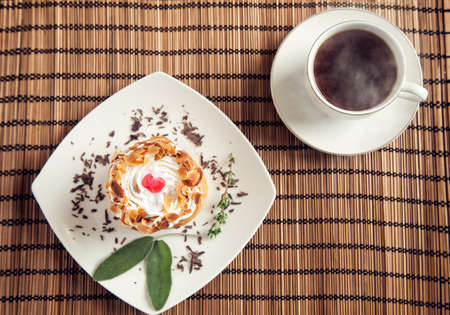 Delicious puff pastry and a fresh coffee with steamの写真素材