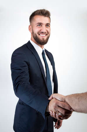 Attractive business man is making a modern hand shakeの写真素材