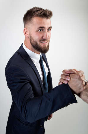 Attractive business man is making a modern hand shakeの写真素材