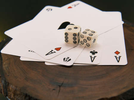Ace playing cards with wite bone dice. Casino betting and gambling concept. Close upの写真素材