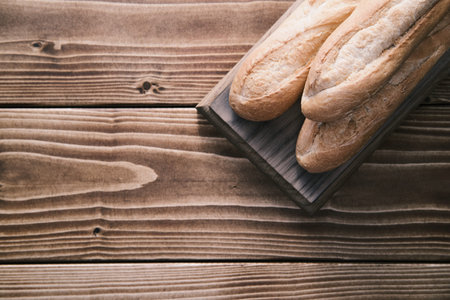 Fresh french baguette on wooden board. ready to eatの写真素材