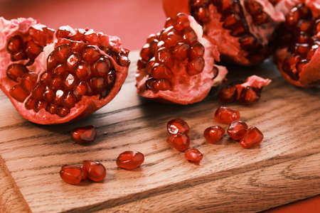 Pomegranate on a wooden board closeupの写真素材