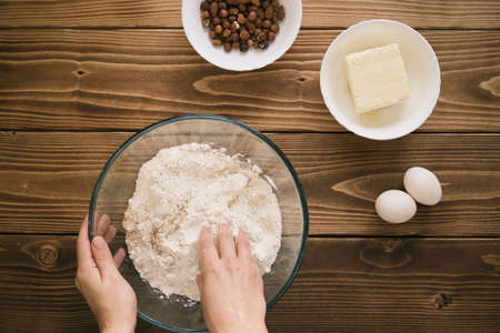 The cook mixes ingredients for apple pie. Ingredients for baking fresh pie. Top view. Toned photoの写真素材