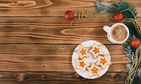 new year star shaped ginger cookies with a cup of coffee on wooden surface