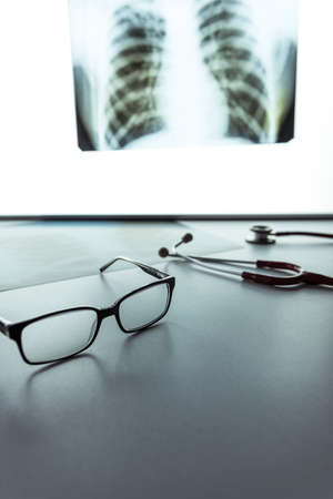 The doctor's desk with glasses and stethoscope. Medical concept with copy spaceの写真素材