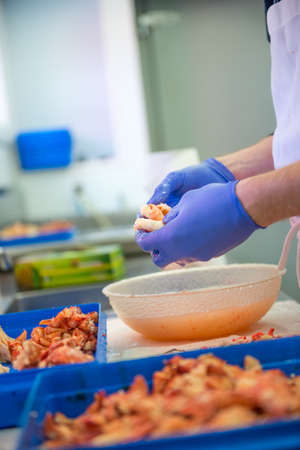 Male hands cleaning the lobster meatの写真素材