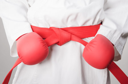 Holding karate belt with glowes, ready for fightの写真素材