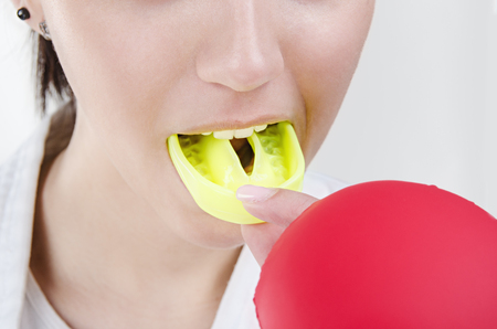 Young boxing woman using mouthguardの写真素材