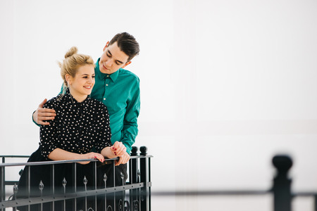 Happy, young couple in their luxurious apartment having great time. Blurred foregroundの写真素材
