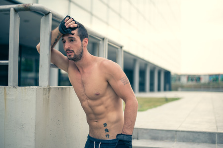 Young proud man relaxing after a very hard workout. Selective focus.の写真素材