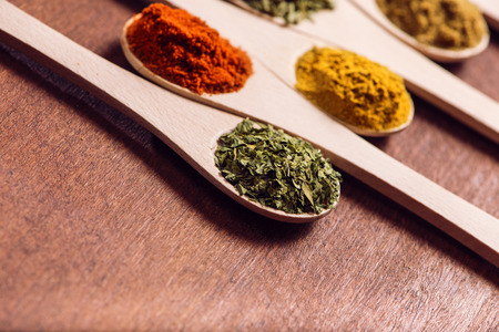 Wooden spoons with spices. Selecive focus.の写真素材