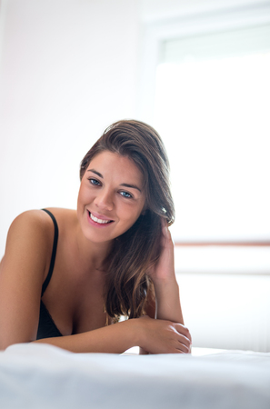 Shot of a beautiful young woman posing in her bedroom.の写真素材