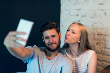 A cute young couple making a selfie. Selective focus.