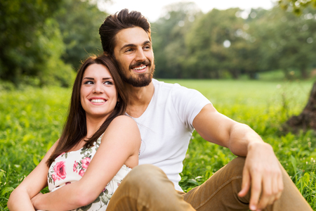 Shot of a happy young couple having romantic time and enjoying a summer picnic.の写真素材