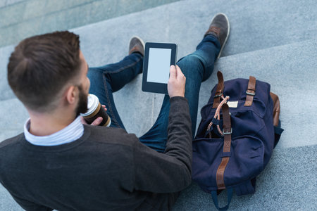 Shot of a young hipster working on his tablet.