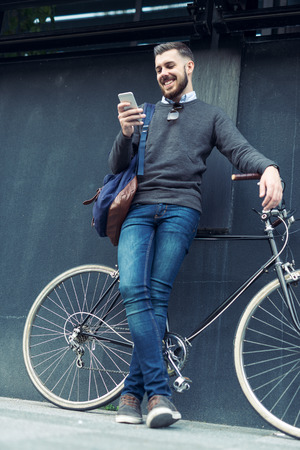 Shot of a stylish man checking his phone.の写真素材