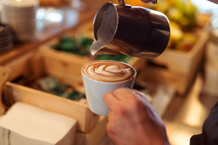 The barista doing the "Latte art". Narrow depth of field.の写真素材