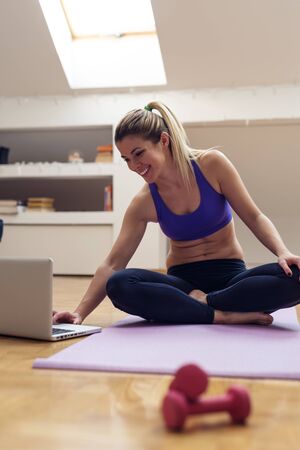 Shot of a woman doing yoga at home.の写真素材