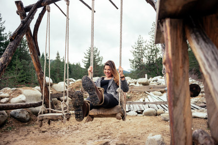 Beautiful woman relaxing on a swing.